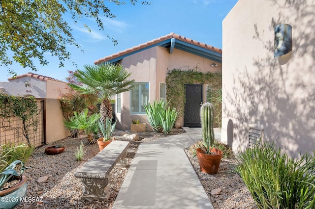 exterior space with stucco siding and fence