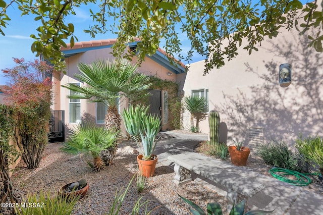 view of home's exterior featuring stucco siding and a tiled roof