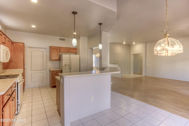 13755 N Buster Spring Way, Oro Valley, AZ 85755 - kitchen with white appliances, light tile patterned floors, a chandelier, light countertops, and recessed lighting