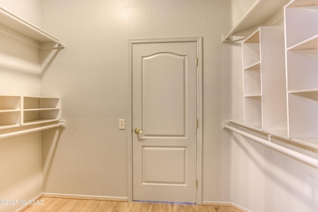 13755 N Buster Spring Way, Oro Valley, AZ 85755 - walk in closet featuring wood finished floors