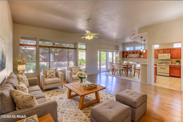 13755 N Buster Spring Way, Oro Valley, AZ 85755 - living room with light wood finished floors and ceiling fan