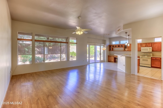 13755 N Buster Spring Way, Oro Valley, AZ 85755 - unfurnished living room featuring light wood-style floors and ceiling fan