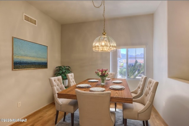 13755 N Buster Spring Way, Oro Valley, AZ 85755 - dining space with a chandelier and wood finished floors