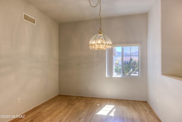 13755 N Buster Spring Way, Oro Valley, AZ 85755 - unfurnished room featuring a chandelier and wood finished floors