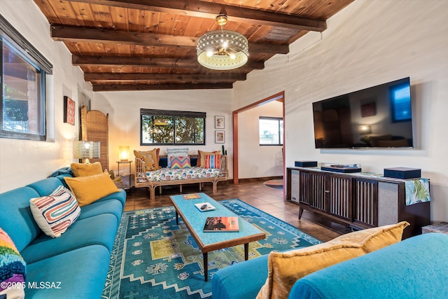 living area featuring tile patterned flooring, beam ceiling, and wooden ceiling