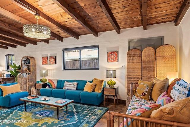 living area featuring beam ceiling, baseboards, wood ceiling, and an inviting chandelier