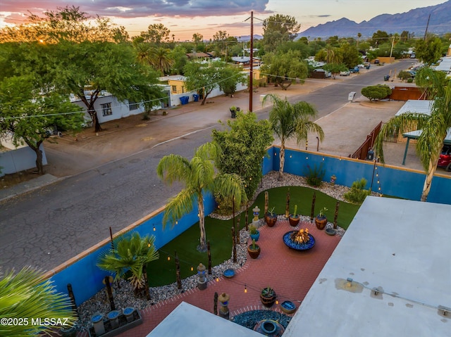 aerial view at dusk featuring a mountain view