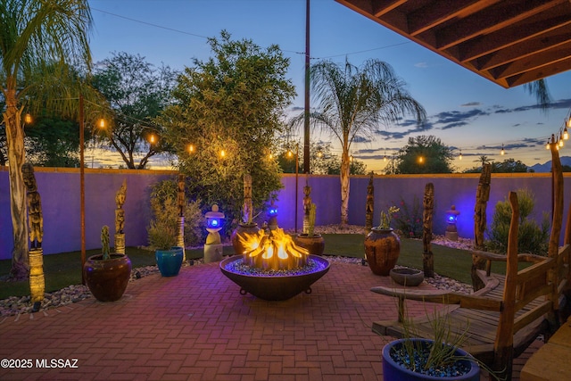 view of patio featuring fence and an outdoor fire pit