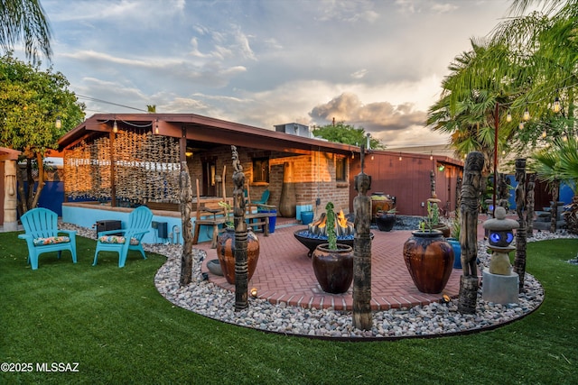 view of patio / terrace featuring a fire pit and fence