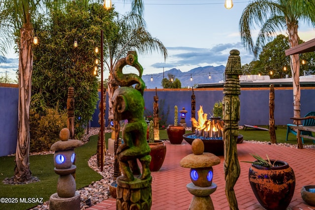 view of patio / terrace featuring a mountain view and fence