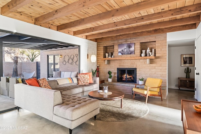 living area featuring beam ceiling, a brick fireplace, finished concrete flooring, and wooden ceiling