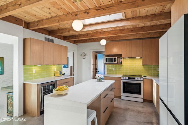 kitchen with finished concrete flooring, wine cooler, appliances with stainless steel finishes, light countertops, and decorative backsplash