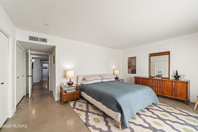 bedroom featuring visible vents, baseboards, and finished concrete floors