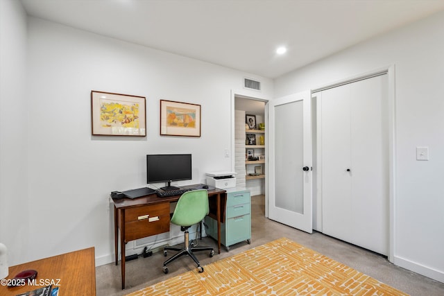 office area with visible vents, baseboards, and finished concrete flooring