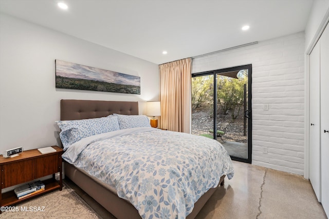 bedroom featuring recessed lighting, a closet, and access to exterior