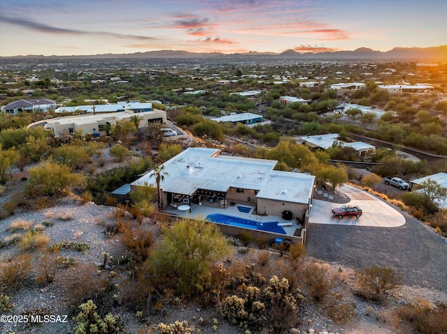 aerial view at dusk featuring a mountain view