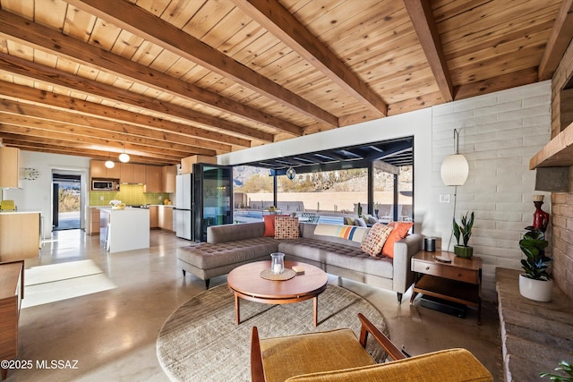 living area featuring beamed ceiling, wood ceiling, and concrete flooring