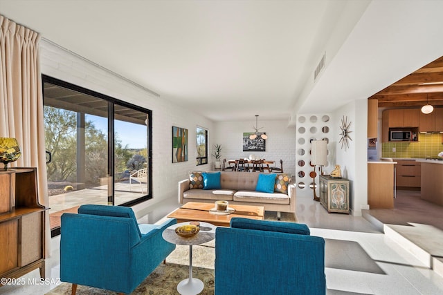 living room with visible vents and brick wall