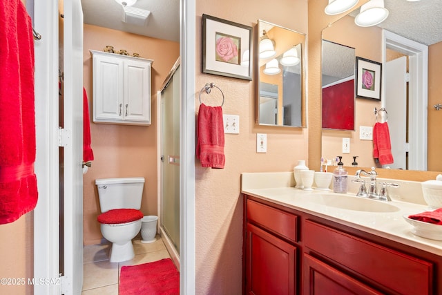 full bath with a stall shower, vanity, toilet, and tile patterned floors