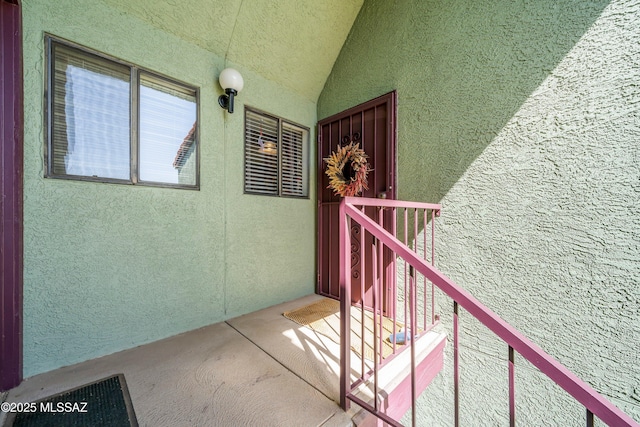 entrance to property featuring stucco siding