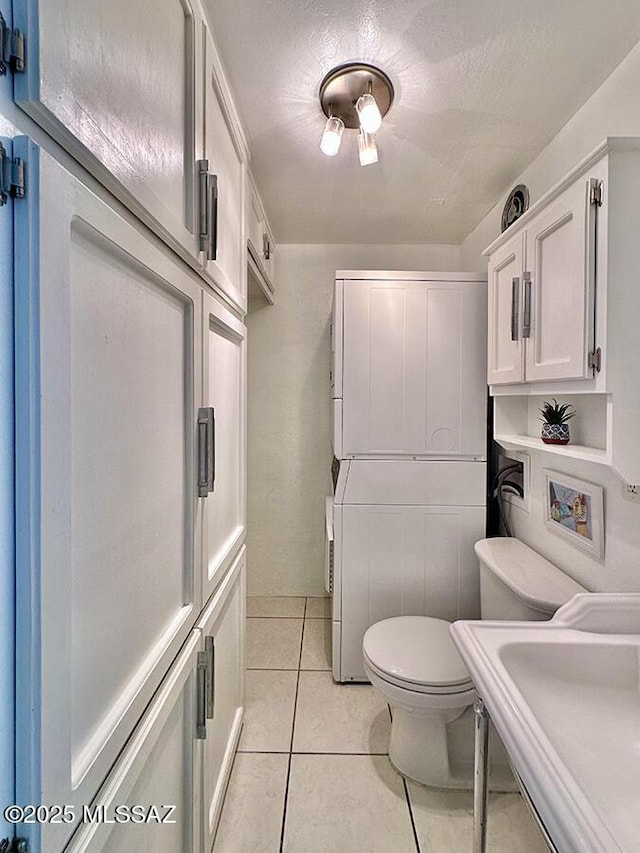 bathroom featuring a sink, tile patterned flooring, and toilet