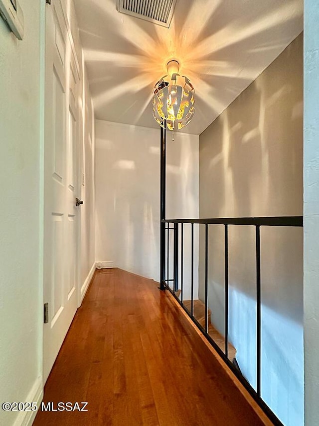 corridor featuring visible vents and wood finished floors