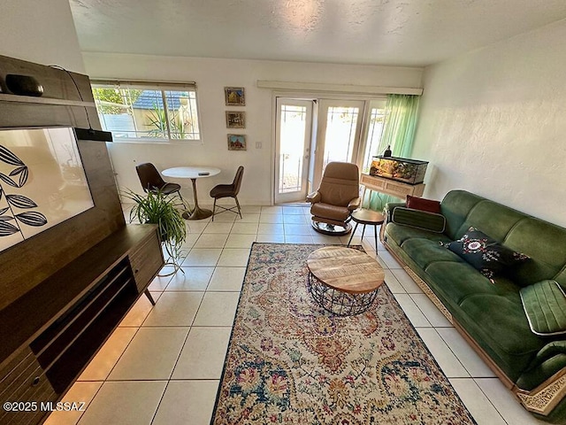 living area featuring plenty of natural light, a textured ceiling, and light tile patterned flooring