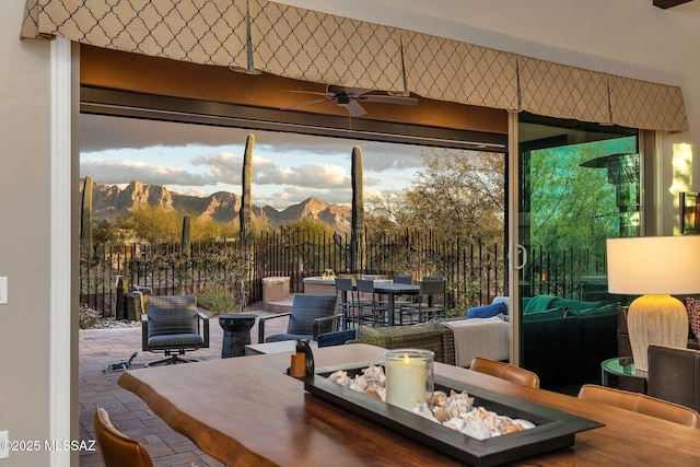 interior space featuring ceiling fan, brick floor, and a mountain view