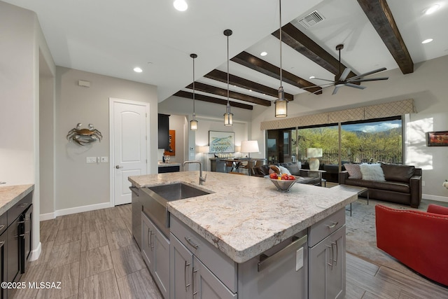 kitchen featuring open floor plan, a sink, visible vents, and gray cabinetry