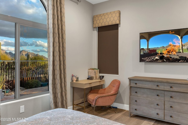 bedroom featuring wood finished floors and baseboards