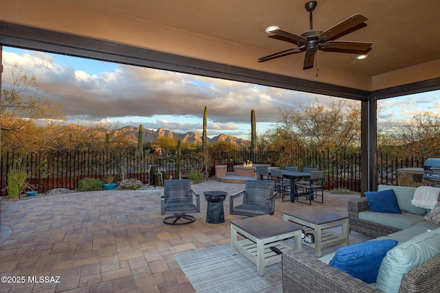 view of patio / terrace with ceiling fan, outdoor dining area, a fenced backyard, grilling area, and an outdoor living space with a fire pit