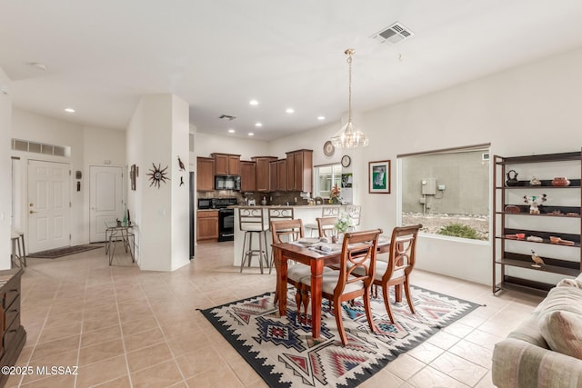 dining room with light tile patterned floors, recessed lighting, visible vents, and a notable chandelier