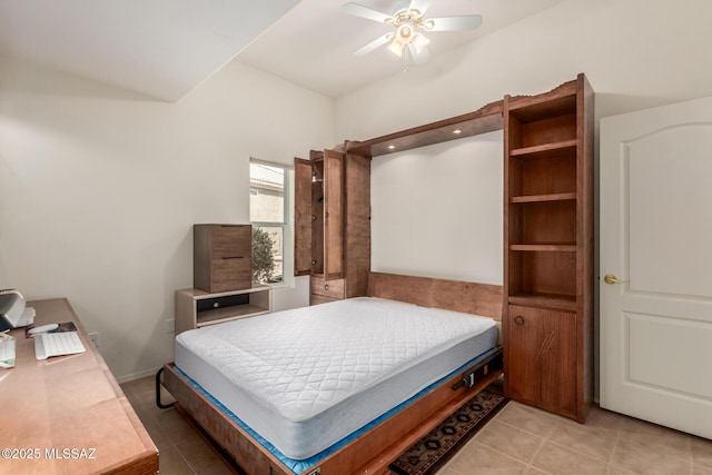 bedroom with light tile patterned floors, ceiling fan, and lofted ceiling