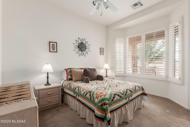 carpeted bedroom with a ceiling fan, visible vents, and baseboards