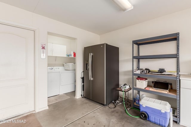 kitchen with open shelves, white cabinets, concrete flooring, stainless steel fridge, and independent washer and dryer