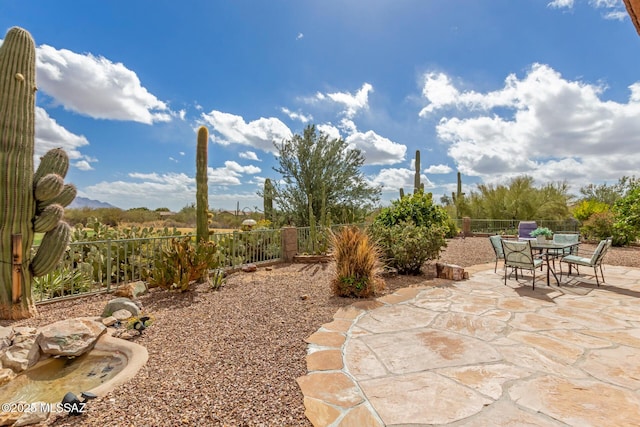 view of patio with a fenced backyard and outdoor dining space