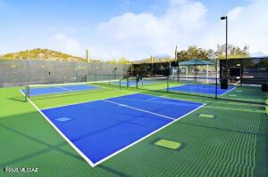 view of tennis court featuring community basketball court and fence