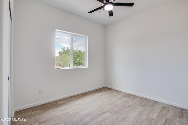 unfurnished room with visible vents, light wood-style flooring, and baseboards