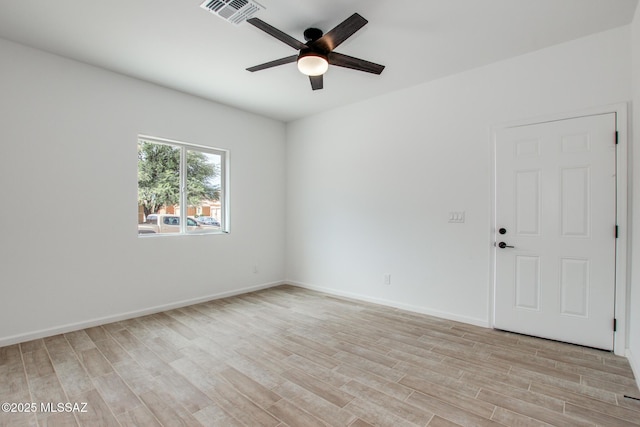 unfurnished room with light wood-type flooring, baseboards, visible vents, and a ceiling fan