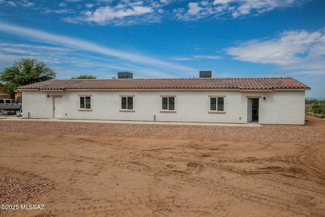 rear view of house with a tiled roof