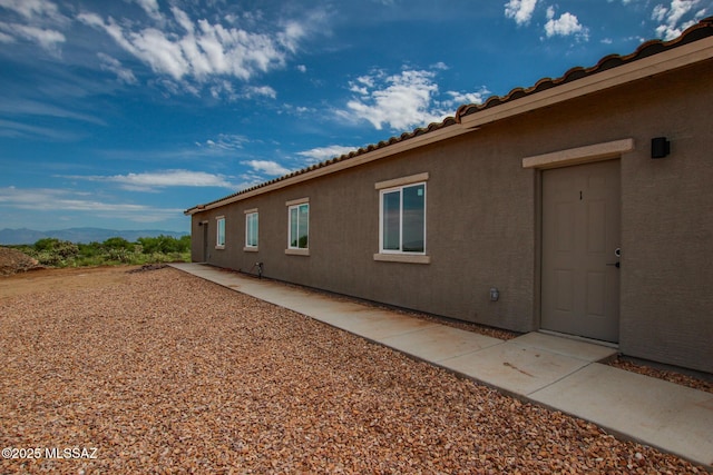 view of property exterior featuring a mountain view and stucco siding