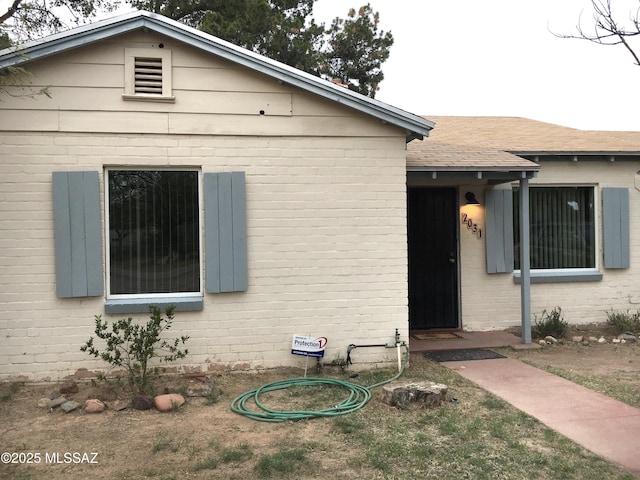 view of front of home featuring brick siding