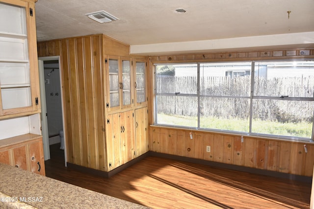 unfurnished sunroom featuring visible vents