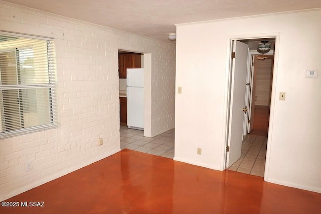 unfurnished room featuring brick wall and ornamental molding