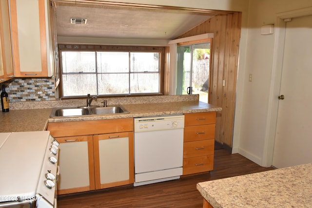 kitchen featuring white dishwasher, stove, a sink, visible vents, and light countertops