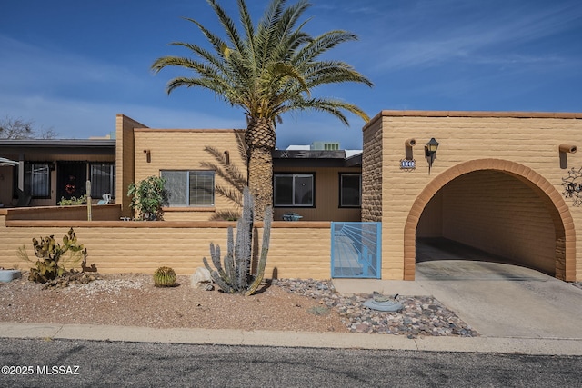 view of front of house featuring a fenced front yard and concrete driveway