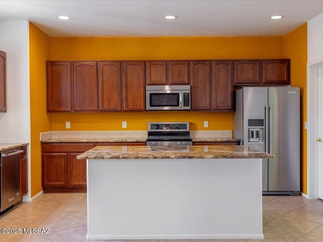 kitchen featuring light stone countertops, light tile patterned floors, and appliances with stainless steel finishes