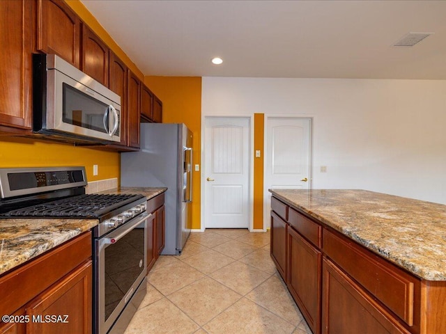 kitchen with light tile patterned floors, recessed lighting, visible vents, appliances with stainless steel finishes, and light stone countertops