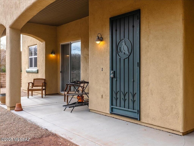 entrance to property with stucco siding