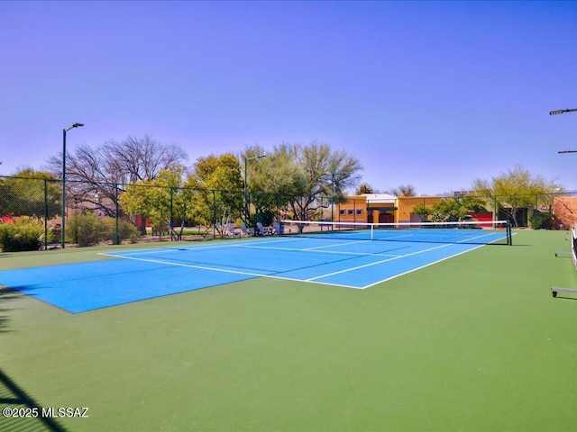 view of tennis court with fence